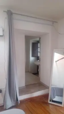 a mirror in front of a room with a bathroom at Nico Homes in Cusco