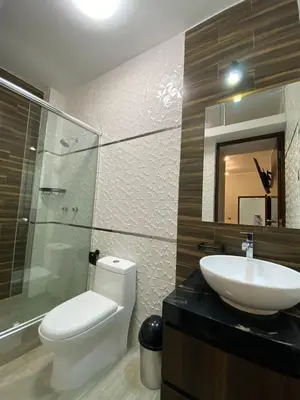a bathroom with a sink and a toilet and a mirror at Ciudad Del Sol Hostel in Ica