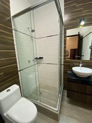 a bathroom with a shower and a toilet and a sink at Ciudad Del Sol Hostel in Ica