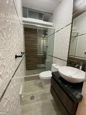 a bathroom with a sink and a toilet and a shower at Ciudad Del Sol Hostel in Ica
