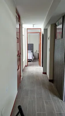 a hallway with a room with a bed and a floor at Departamento Céntrico y Acogedor in Huancayo