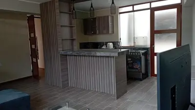 a kitchen with a counter top in a room at Departamento Céntrico y Acogedor in Huancayo