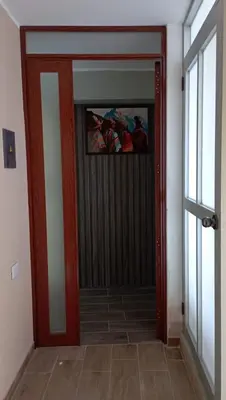 a door in a room with a window and a door at Departamento Céntrico y Acogedor in Huancayo