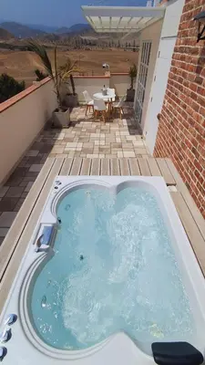 a hot tub on the patio of a house at Hermoso Penthouse con jacuzzi en terraza in Lima