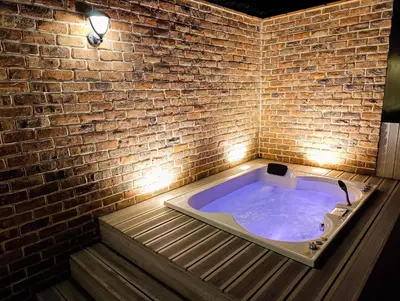 a jacuzzi tub in a brick wall at Hermoso Penthouse con jacuzzi en terraza in Lima