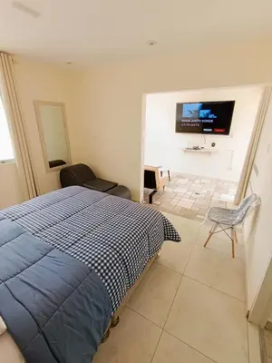 a bedroom with a bed and a tv on a wall at Hermoso Penthouse con jacuzzi en terraza in Lima