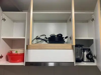 a cupboard filled with pots and pans in a kitchen at Vive Cerca a Miraflores Apart. in Lima