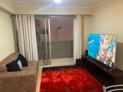 a living room with a large flat screen tv at Vive Cerca a Miraflores Apart. in Lima