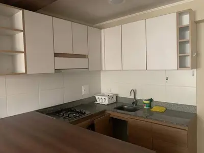 a kitchen with white cabinets and a sink at Vive Cerca a Miraflores Apart. in Lima
