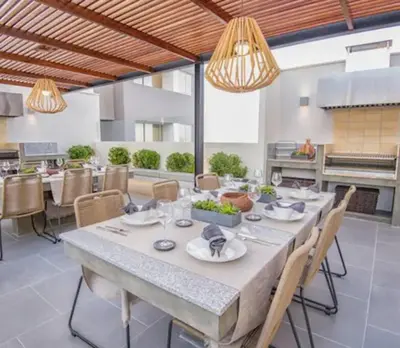 a dining room with a large table with chairs at Vive Cerca a Miraflores Apart. in Lima