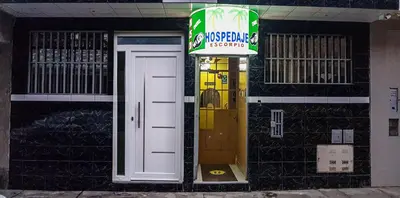 a front door of a restaurant with a sign on it at Hospedaje Escorpio in Lima