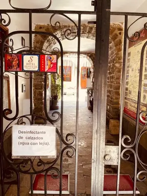 a gate with a sign in front of a door at Hotel Sevilla in Ayacucho