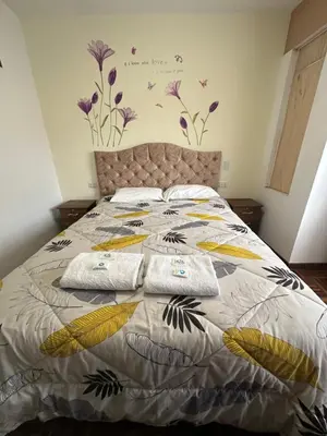 a bedroom with a bed with two towels on it at PAKARINA HOUSE in Cusco