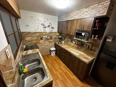 a kitchen with a sink and a microwave at PAKARINA HOUSE in Cusco