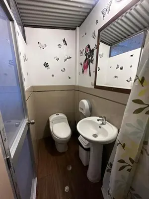 a small bathroom with a toilet and a sink at PAKARINA HOUSE in Cusco