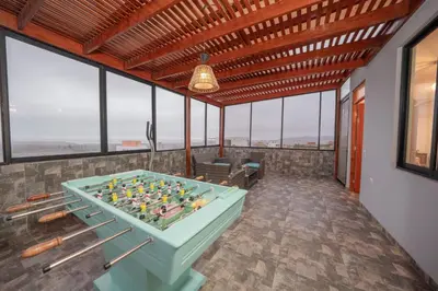 a pool table in a room with windows at Mar y campo Casa Huarca in La Isla