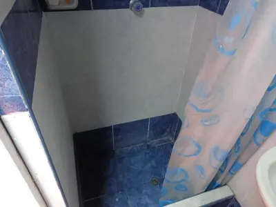 a bathroom with a shower with a toilet and a sink at Agua dulce in Lima
