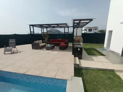 a patio with a couch and a pool at Alquilo Casa playa in San Antonio