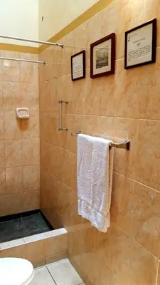 a bathroom with a shower with a toilet and a towel at Kanata Properties 2 in Lima
