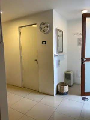 a door in a room with a clock on the wall at Lince Apartments in Lima