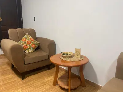 a living room with a chair and a table at Skyhousecusco in Cusco