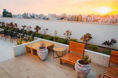 a balcony with benches and a table and chairs at Apartamento de Ensueño LINCE in Lima
