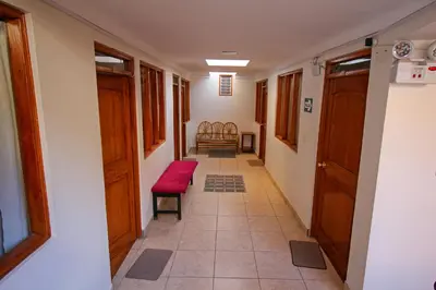 a hallway with a red bench in a room at El Chasqui in Ollantaytambo