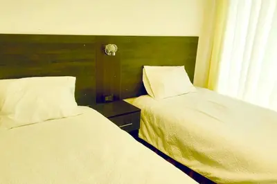 two beds sitting next to each other in a bedroom at Apartamento Andahuaylas in Andahuaylas