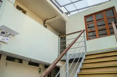 a staircase in a building with a skylight at Inkawasi Miraflores Hostel in Lima