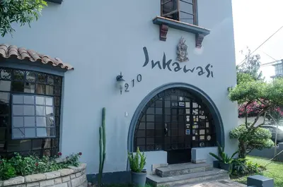 a blue building with a sign that reads kindness at Inkawasi Miraflores Hostel in Lima