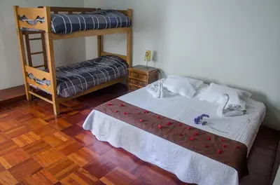 a bedroom with a bed and a bunk bed at Inkawasi Miraflores Hostel in Lima