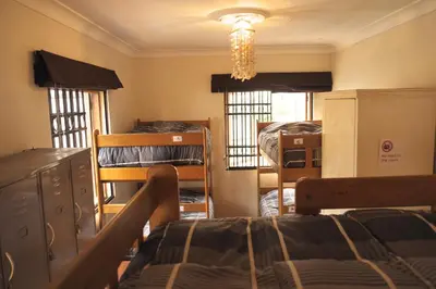 a dorm room with a bed and a chandelier at Inkawasi Miraflores Hostel in Lima