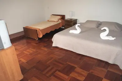 two swans are sitting on two beds in a room at Inkawasi Miraflores Hostel in Lima