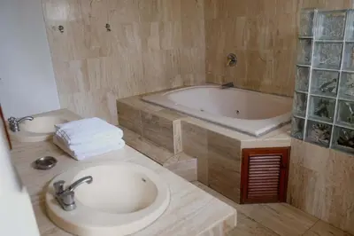 a bathroom with a sink and a bath tub at Inkawasi Miraflores Hostel in Lima