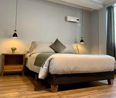 a bedroom with a large bed with a nightstand and a bed sidx sidx sidx at Casa Encuentro San Blas in Cusco