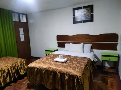 a hotel room with a bed with a tray on it at Sierra Verde - Muy Céntrico Hs in Huancayo