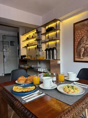 a table with plates of food on top of it at Casa Tiyay Cusco in Cusco