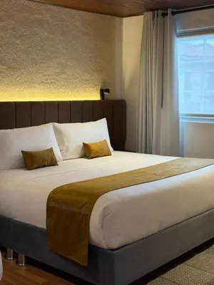 a large bed with two pillows on top of it at Casa Tiyay Cusco in Cusco
