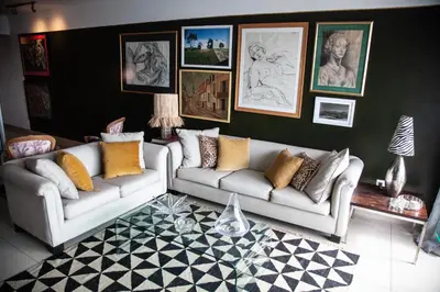 a living room with two couches and pictures on the wall at Chic Miraflores AC HEATER 16th floor in Lima