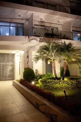 a building with palm trees in front of it at Chic Miraflores AC HEATER 16th floor in Lima