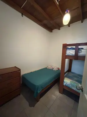 a bedroom with a bunk bed and a dresser at Playa Arica Backpackers in Arica