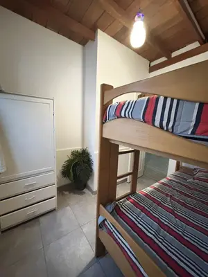 a bedroom with a bunk bed and a dresser in a room at Playa Arica Backpackers in Arica