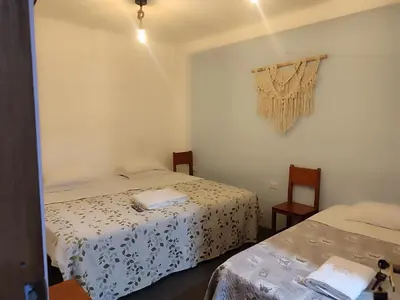 a room with two beds in a room at Hospedaje Hamuy's Lodge in Ica