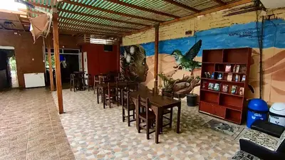 a dining room with tables and chairs and a mural at El Boulevard de Huacachina in Ica