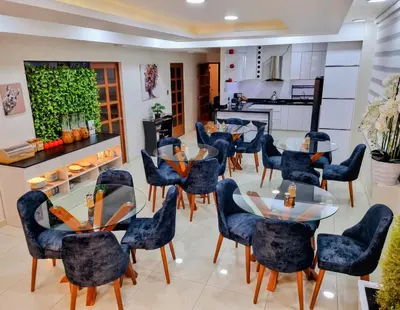 a dining room with blue chairs and tables at Hotel del Valle in Huancayo