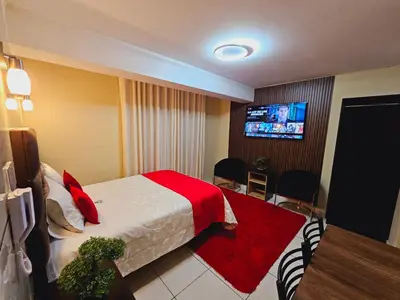 a hotel room with a bed and a flat screen tv at Hotel del Valle in Huancayo