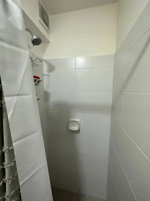 a white bathroom with a shower with a shower at Apartamento de estreno San Bartolo vista Piscina Playa in San Bartolo