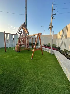a playground on a balcony with green grass at Apartamento de estreno San Bartolo vista Piscina Playa in San Bartolo