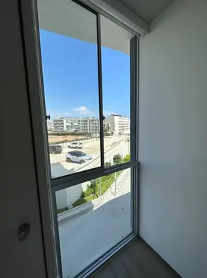 an open window with a view of a street at Apartamento de estreno San Bartolo vista Piscina Playa in San Bartolo
