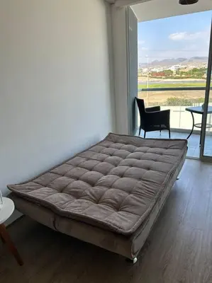 a large bed in a room with a large window at Apartamento de estreno San Bartolo vista Piscina Playa in San Bartolo